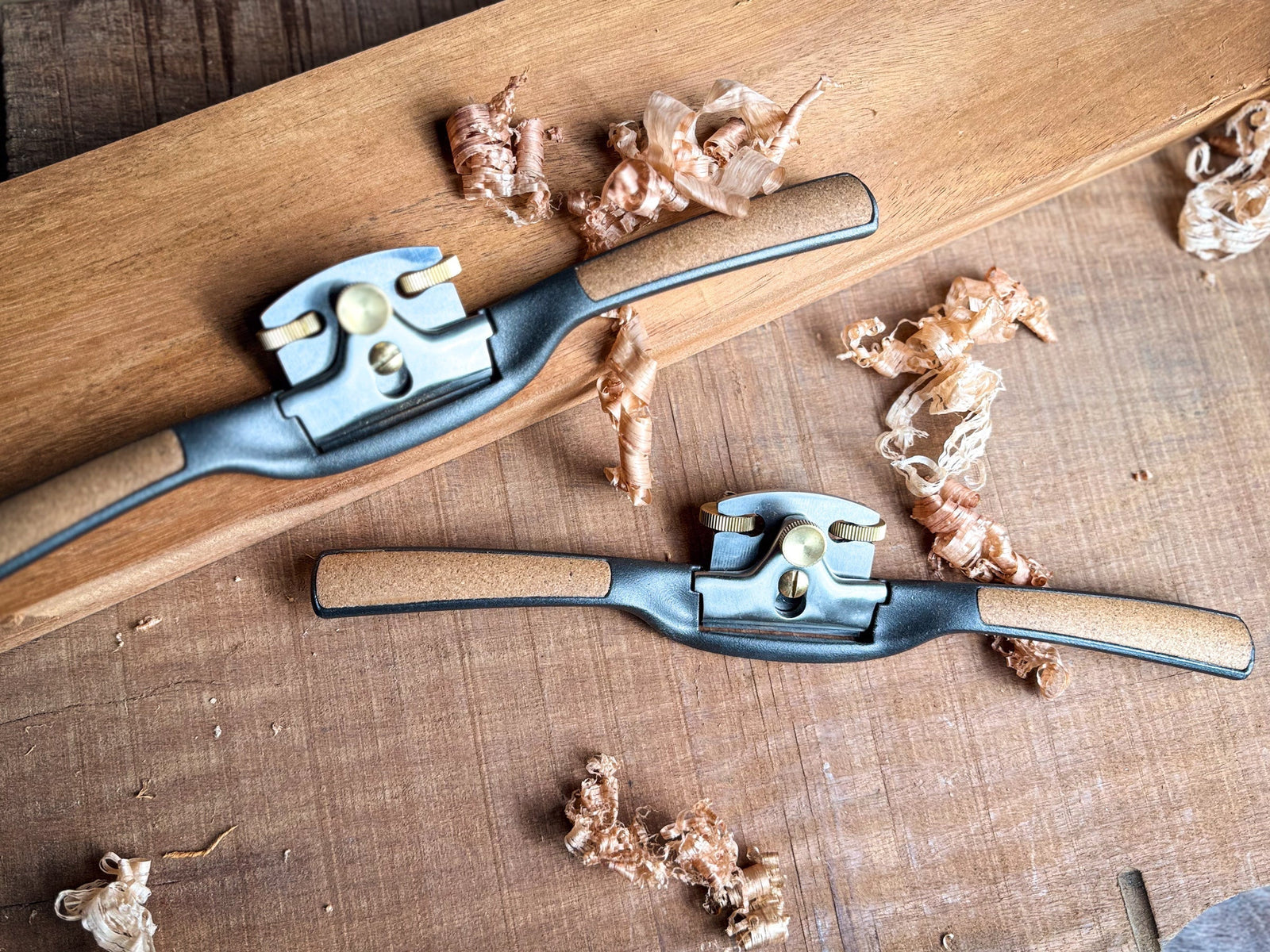 The Melbourne Tool Company flat and round sole spokeshaves displayed on a workbench